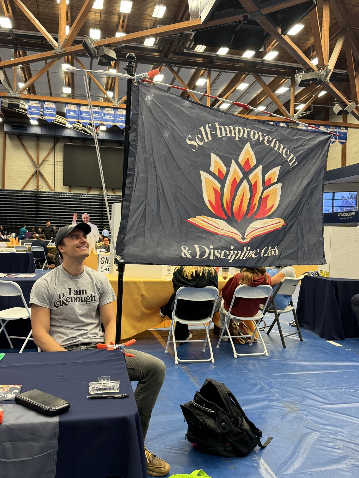 Ethan Dickson seated at a Self-Improvement Club table
